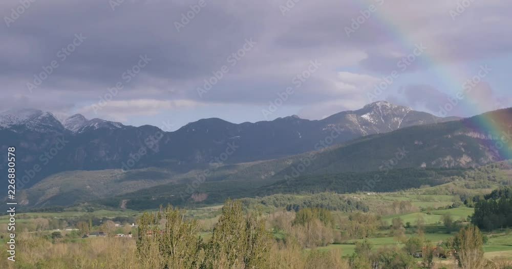 Catalonia, Spain. Pyrenees Mountains Landscape With Rainbow Above Spring Forest And Hills. Spring Nature Catalonia, Spain. Pyrenees Mountains Landscape With Rainbow Above Spring Forest And Hills. Spring Nature