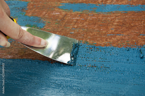 renovation furniture - removing blue painting with spatula