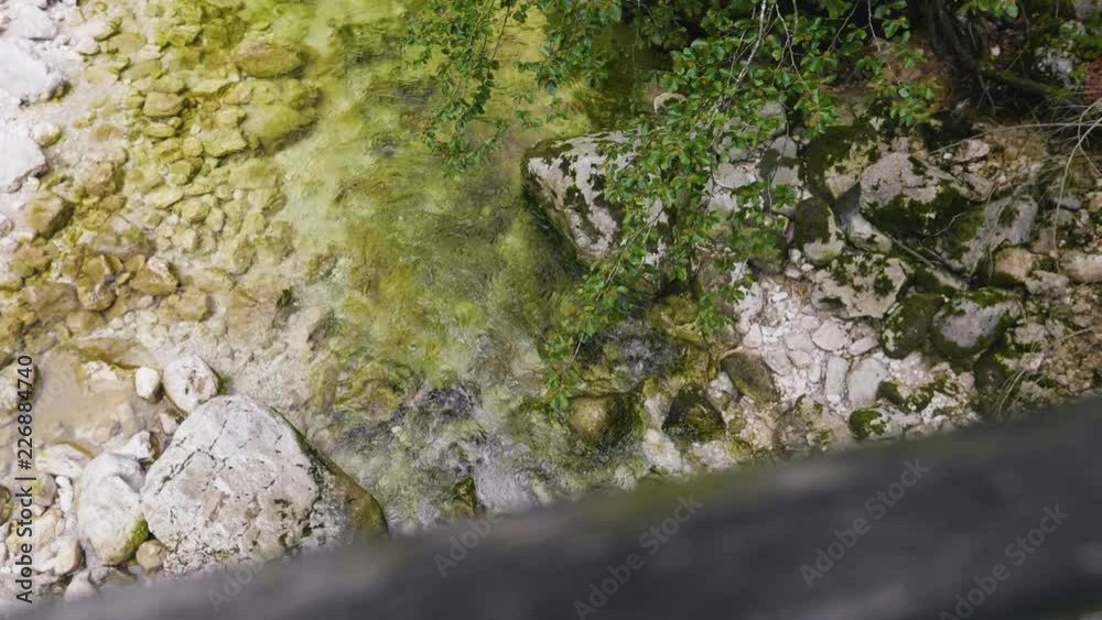 Salzburgerland Austria, young woman walking on bridge steaming river mountains