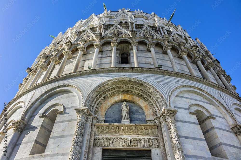 The Baptistery of St. John (Battistero di San Giovanni, 1363) at Piazza dei Miracoli (Square of Miracles) in Pisa. Baptistery is Unesco world heritage site. Pisa, Tuscany, Italy, Europe.