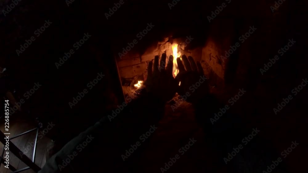 POV, warming hands by fireplace