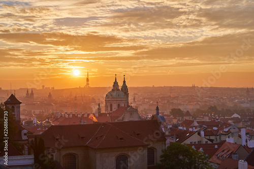 Landcape or cityscape view on old town of Prague and Lesser town during the golden hour in sunrise with beautiful clouds and sun light taken from hill of prague castle. 