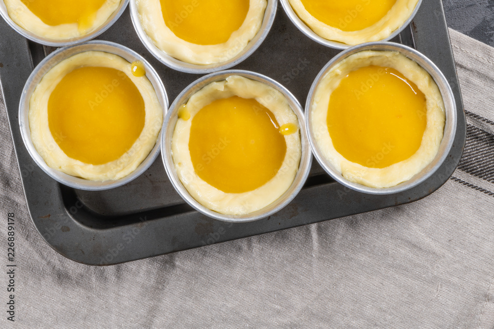 Traditional portuguese dessert pastel de nata before going to the oven. Dough of custard egg tarts Traditional portuguese dessert pastel de nata before going to the oven. Dough of custard egg tarts