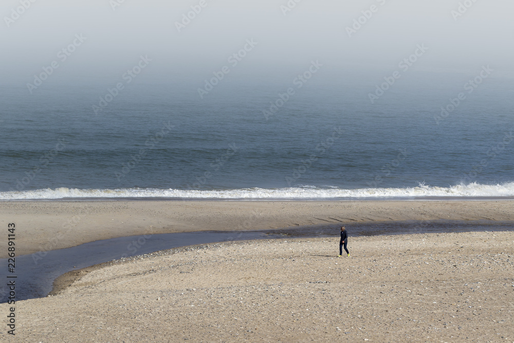 Walk on a beach with fog