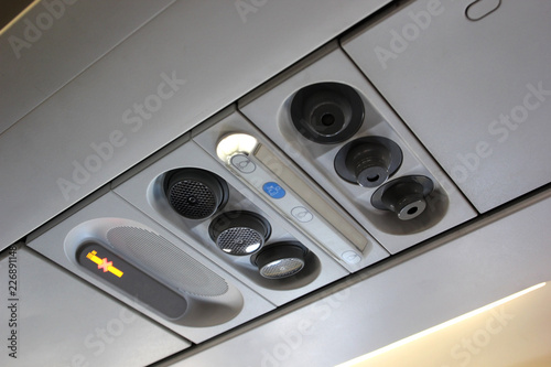 air grille diffuser and lamp on ceiling in the airplane