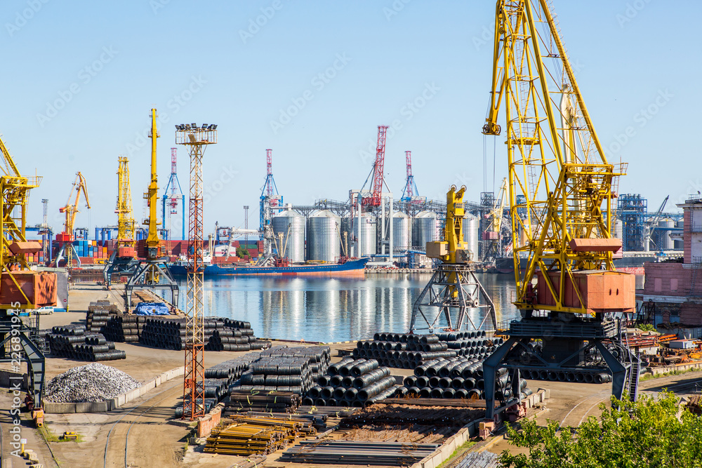 Industrial landscape port terminal general cargo. Port terminal for transshipment of steel, iron ingots, steel pipes and sheet steel