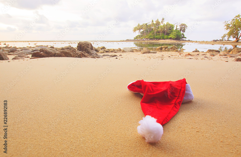 Christmas Santa hat on the beach. are texture Nature background creative tropical layout made at phuket Thailand Christmas Santa hat on the beach. are texture Nature background creative tropical layout made at phuket Thailand