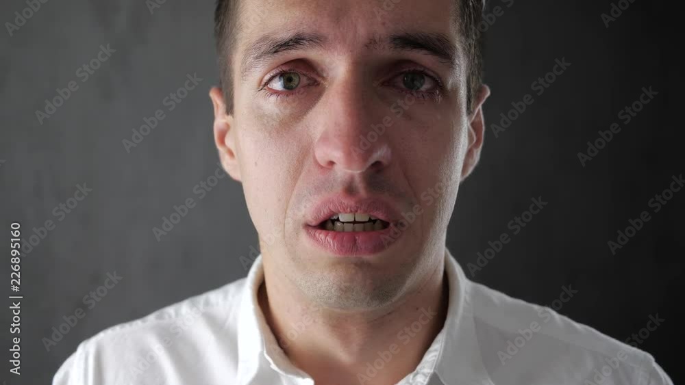 Portrait of sad man crying with tears in eyes. Depressed businessman crying. Man in despair.