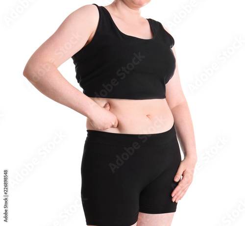 Overweight woman touching belly fat before weight loss on white background
