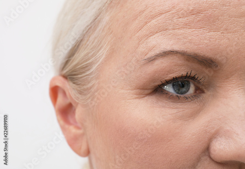 Closeup view of beautiful older woman on white background photo