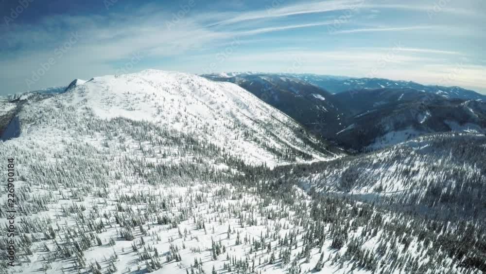 Wide aerial, vast mountain landscape in winter