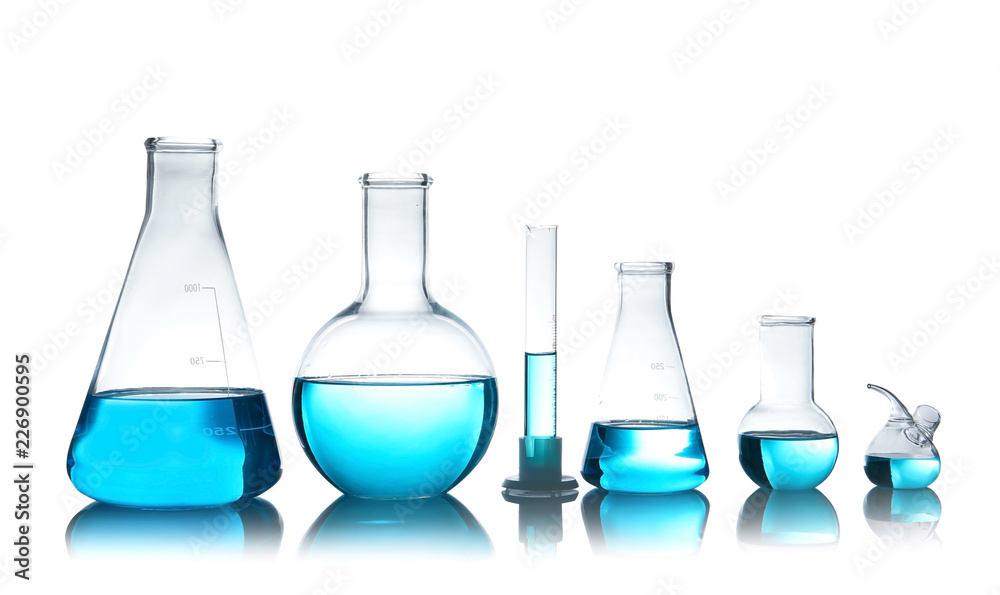 Laboratory glassware for chemical analysis with blue liquid on table against white background Laboratory glassware for chemical analysis with blue liquid on table against white background