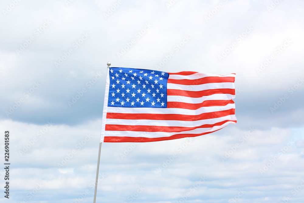 American flag fluttering outdoors on cloudy day