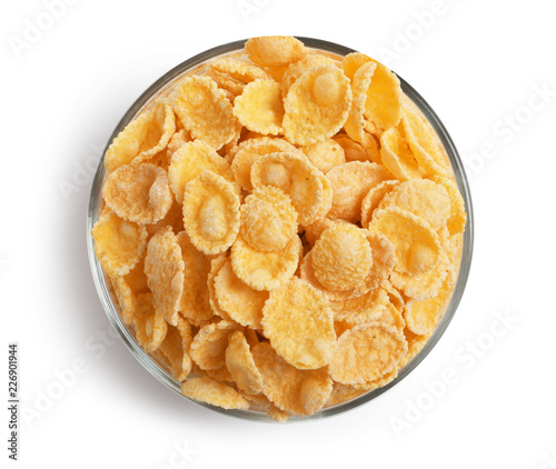 Bowl with crispy cornflakes on white background, top view