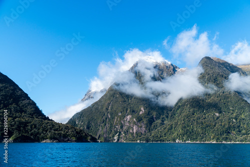 Mountains in milford sound covered by low cloud