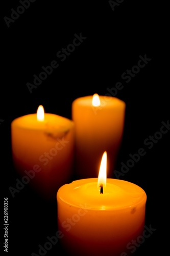 Close-Up of Three Lit Candles on Black Background