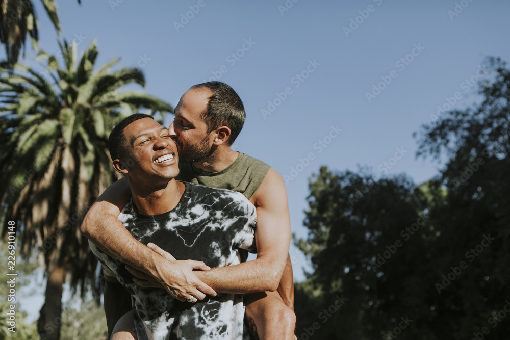Fototapeta premium Gay couple hugging in the park