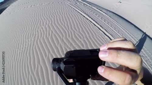 POV close up, setting up camera in Mojave desert