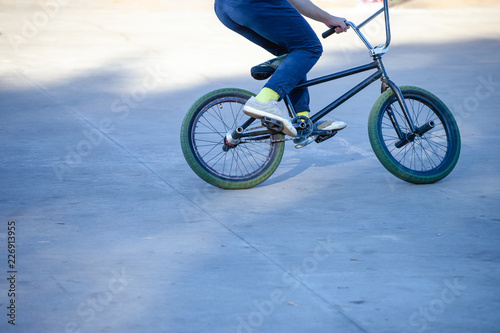 young guy with a sports bike is preparing to jump