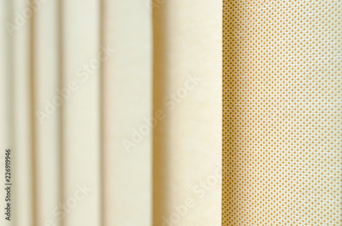 window curtain in closeup showing the texture in shades of beige. blurred background. © PauloPJ             
