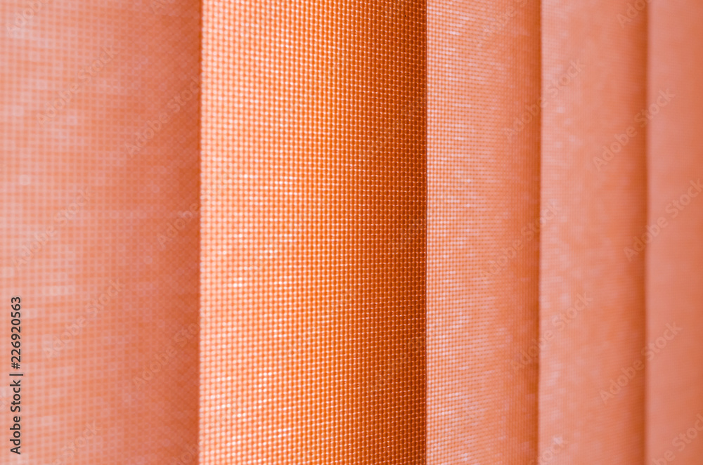 window curtain in closeup showing texture in salmon shades. blurred background. gradient. window curtain in closeup showing texture in salmon shades. blurred background. gradient.