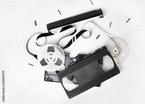 Video Cassette tape or VHS video cartridge exploded in to parts. Isolated on white.