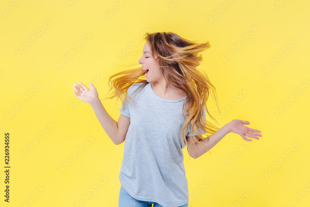 Emancipated girl turns her hair around with her head flying away, looking to left. Emancipated girl turns her hair around with her head flying away, looking to left.