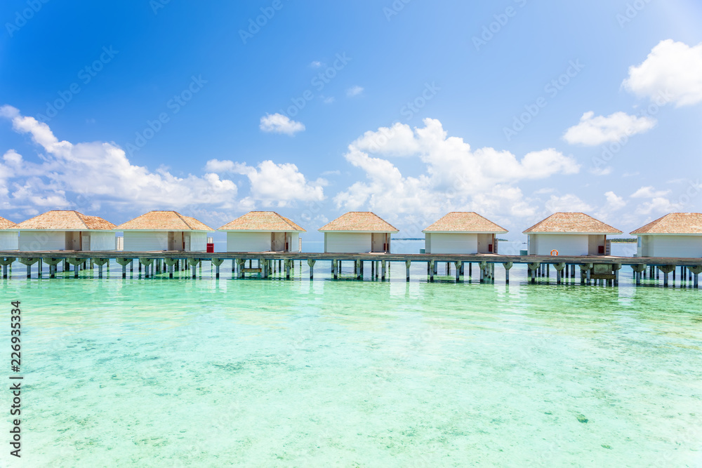 Tropical Water villas on Maldives island in the morning, holiday vacation background concept
