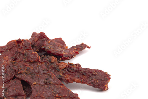 Pile of Black Pepper Beef Jerky on a White Background