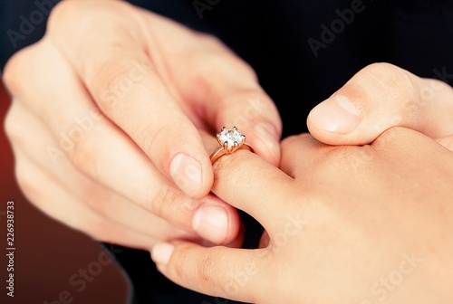 Close up Groom Putting the Wedding Ring © BillionPhotos.com