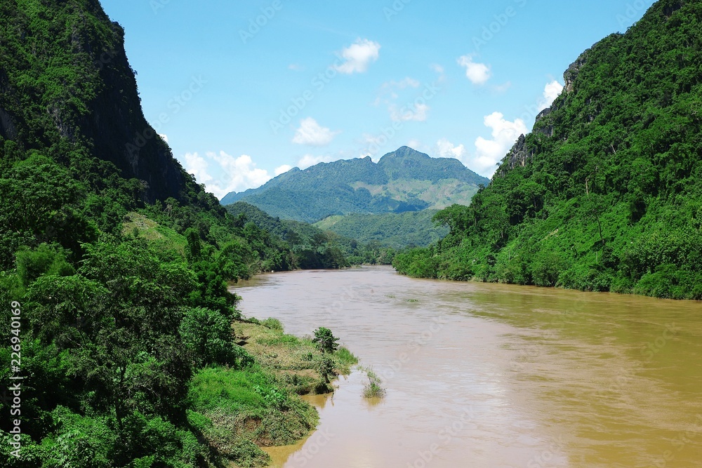 tropical river with hills mountains and the lush cloud forest
