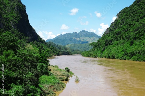 tropical river with hills mountains and the lush cloud forest © simanlaci