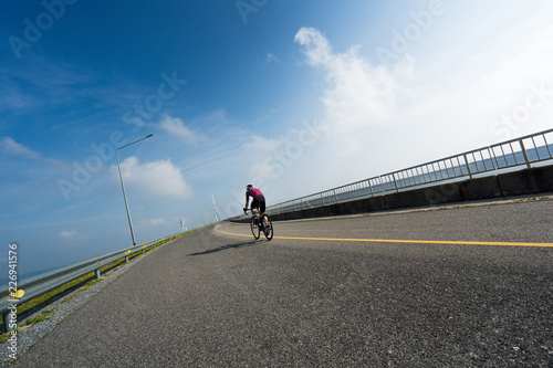 Asian man cycling road bike in the morning