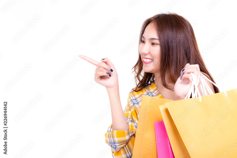 Attractive beautiful shopping woman point finger to copy space isolated on white background. Charming beautiful woman get satisfy, happiness or love product, goods. Use for commercial, advertising Attractive beautiful shopping woman point finger to copy space isolated on white background. Charming beautiful woman get satisfy, happiness or love product, goods. Use for commercial, advertising