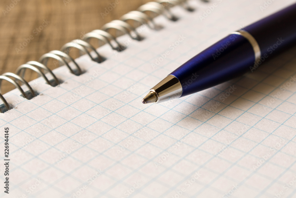 Pen with notebook on wooden table . Close up. Concept of education Pen with notebook on wooden table . Close up. Concept of education