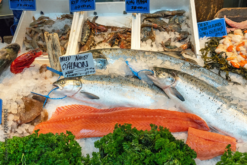 Salmon fillet and other fish and seafood for sale at a market in London photo