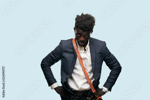 young black businessman looking angry, unhappy and frustrated, gesturing furiously, feeling upset and annoyed. photo