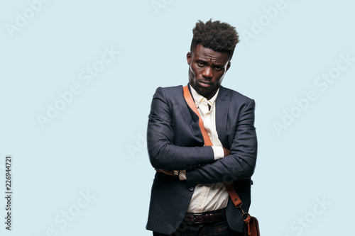 young black businessman looking angry, unhappy and frustrated, gesturing furiously, with arms crossed, feeling upset and annoyed. photo