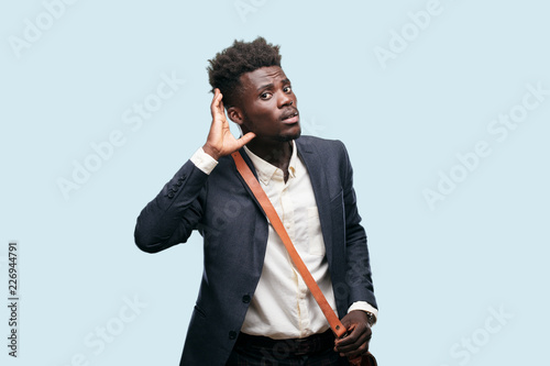 young black businessman paying attention, trying to hear and listen to what is being said, lending an ear. photo