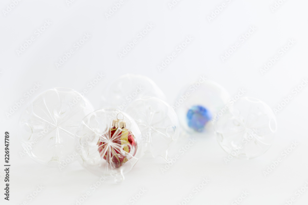 Still life with beautiful decorative transparent, red and blue christmas glass balls on white background Still life with beautiful decorative transparent, red and blue christmas glass balls on white background