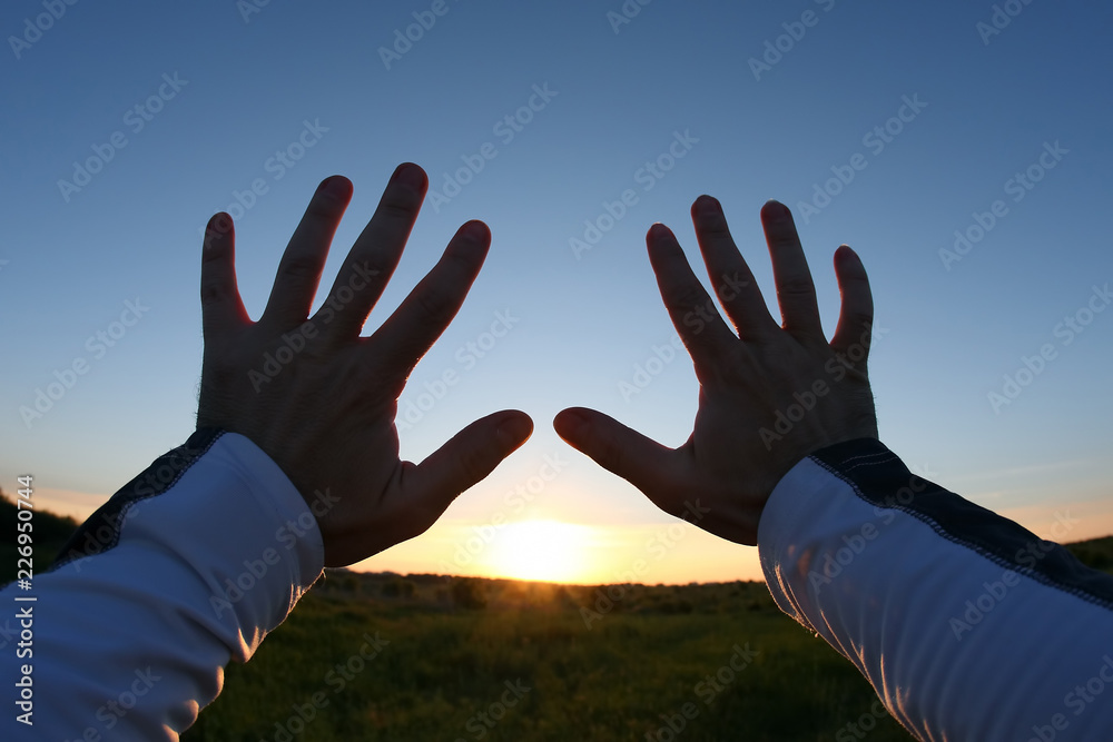 lifted up hands in the background of the sunset lifted up hands in the background of the sunset