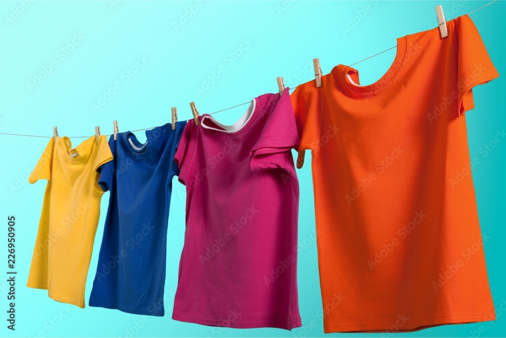 Colorful t-shirts hanging on rope