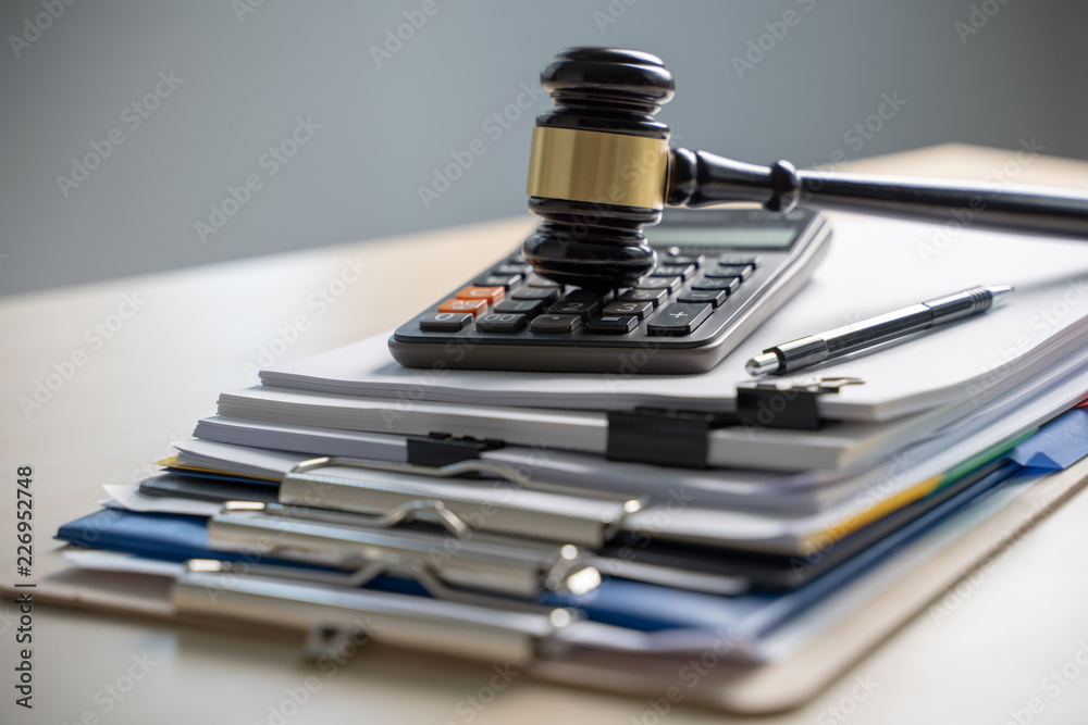 Judge hammer and business report papers, important documents Judge hammer and business report papers, important documents