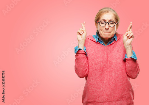Принти на полотні Beautiful senior woman making a sincere, honorable promise or oath, solemnly swearing with one hand over heart