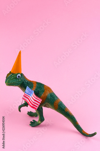 plastic funny green dinosaur with USA flag © dvulikaia