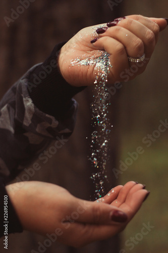 silver sequins in female hands