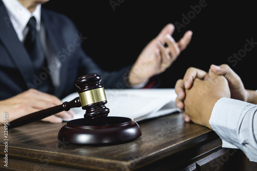 Meeting and collaboration concept, Businessman and Male lawyer or judge consult having team meeting with client discussing of contract in courtroom
