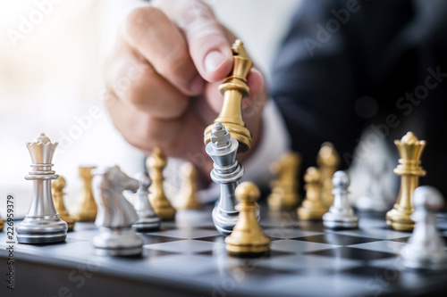 Hands of confident businessman playing chess game to development analysis new strategy plan, leader and teamwork concept for win and success