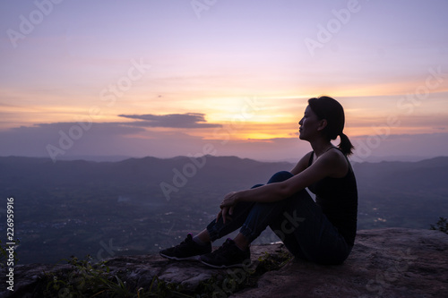 Fototapeta Naklejka Na Ścianę i Meble -  silhouette woman sitting on mountain