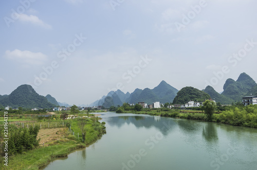 Beautiful karst mountains are visible on blue sky background on summer sunny day.